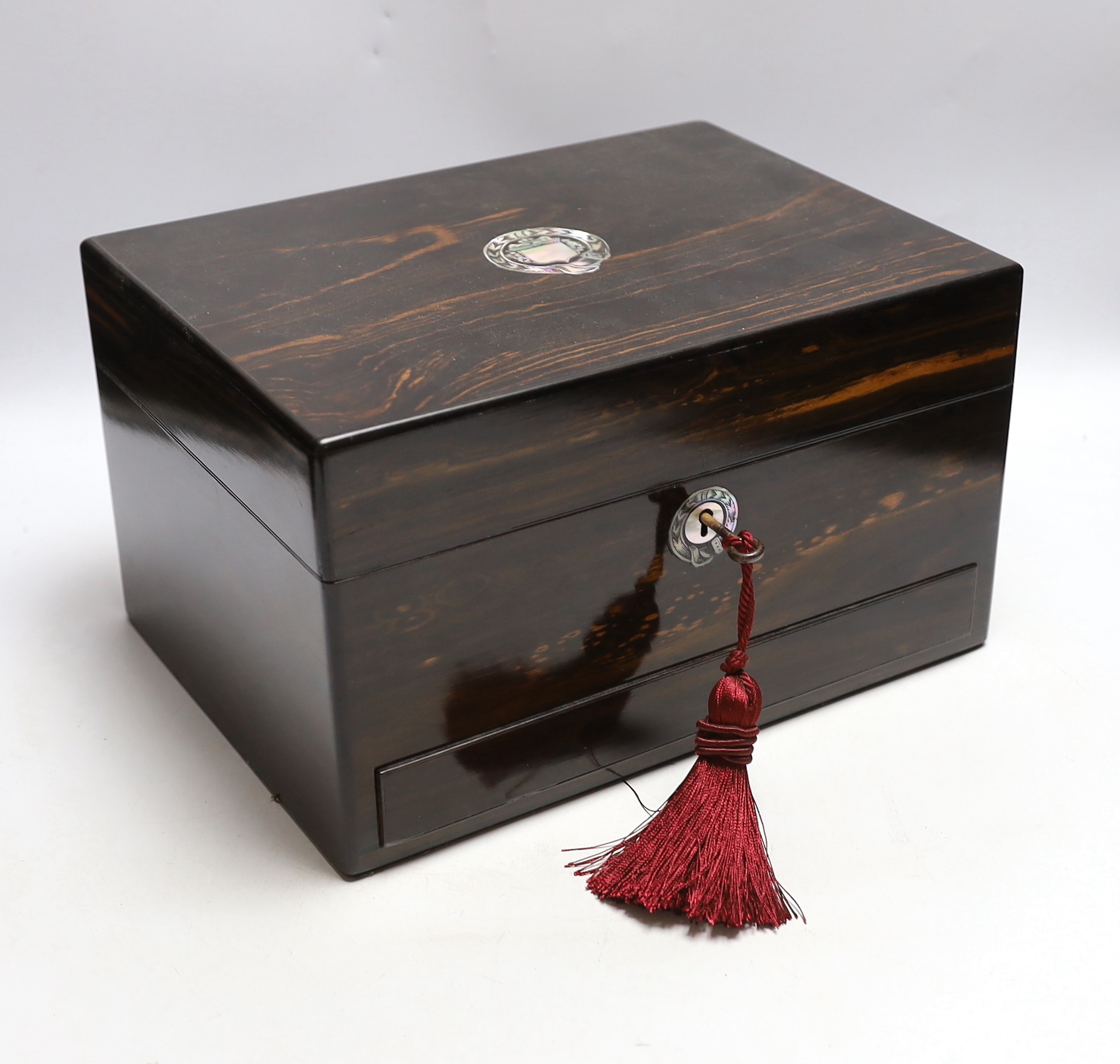 A Victorian coromandel wood toilet box with plated fittings and Mother of Pearl inlay to lid, fitted internal compartments containing glass bottles with plated lids and other accessories, and jewellery drawer underneath